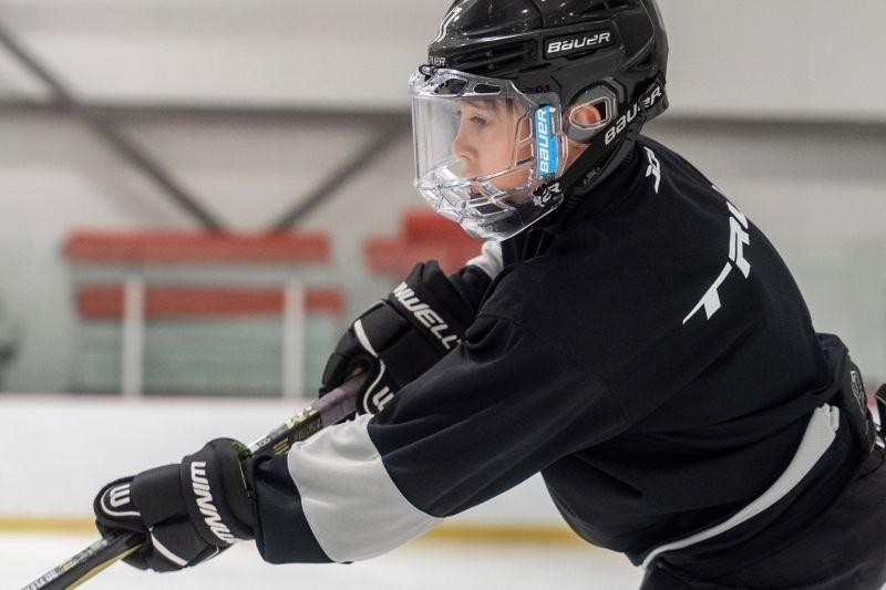 Image of kid shooting the puck